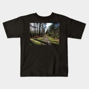 Trees in Swinley forest make it great place for sunlight walk Kids T-Shirt